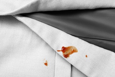 Photo of Dirty jacket with stains of sauce, top view