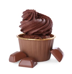 Photo of One delicious cupcake and chocolate pieces isolated on white