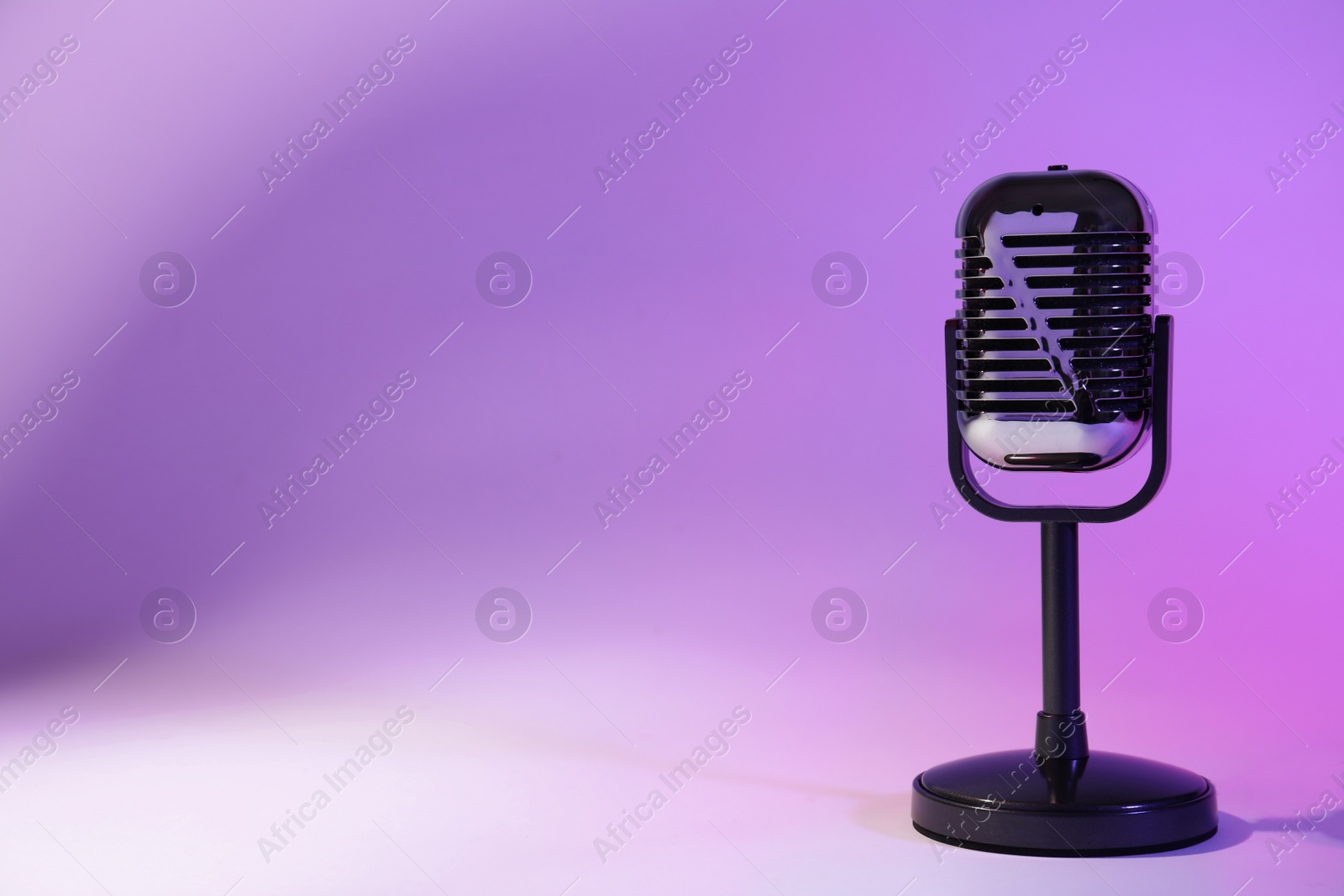 Photo of Retro microphone on color background. Space for text