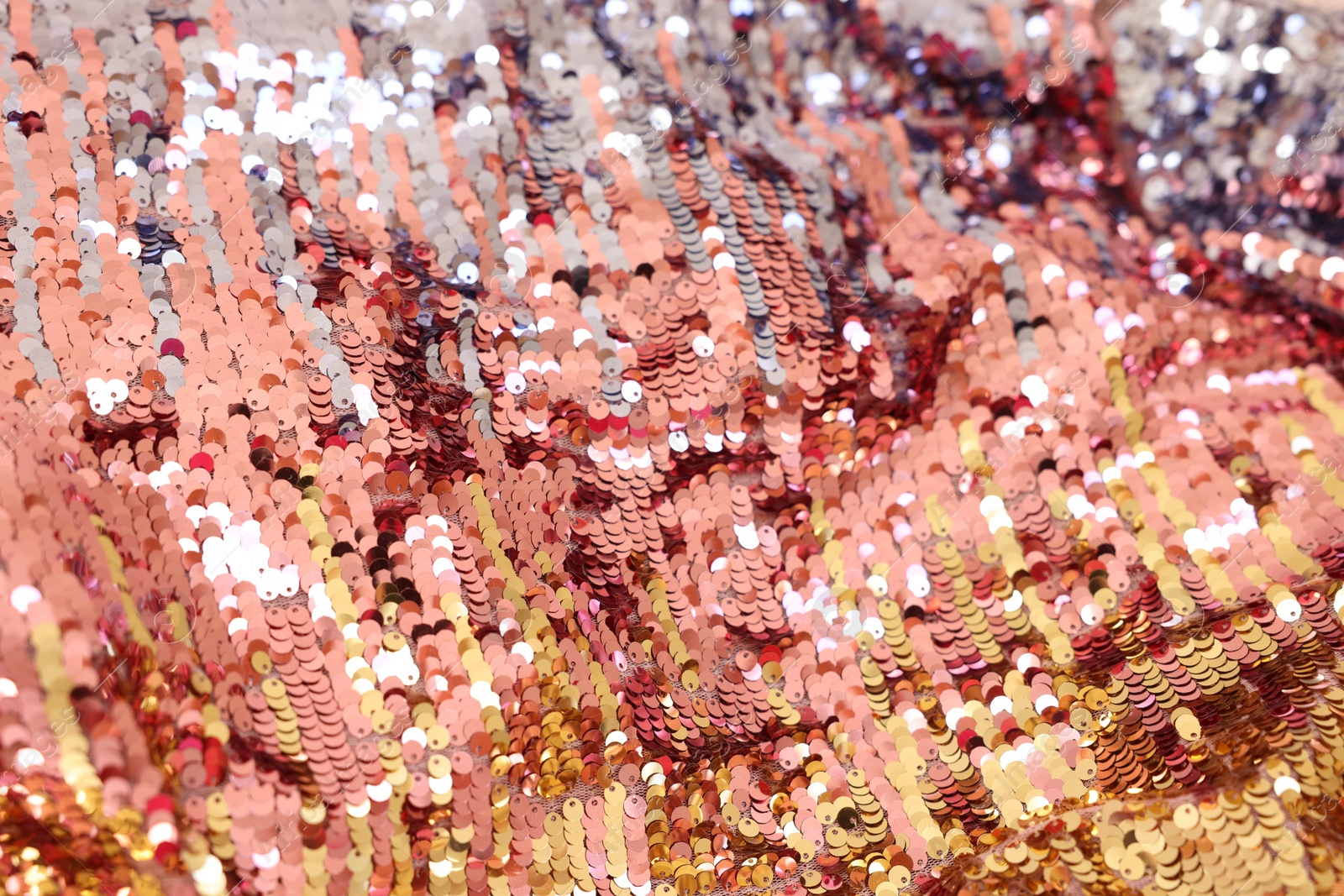 Photo of Texture of stylish pink carnival dress with sequins as background, closeup