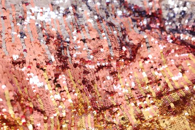 Photo of Texture of stylish pink carnival dress with sequins as background, closeup