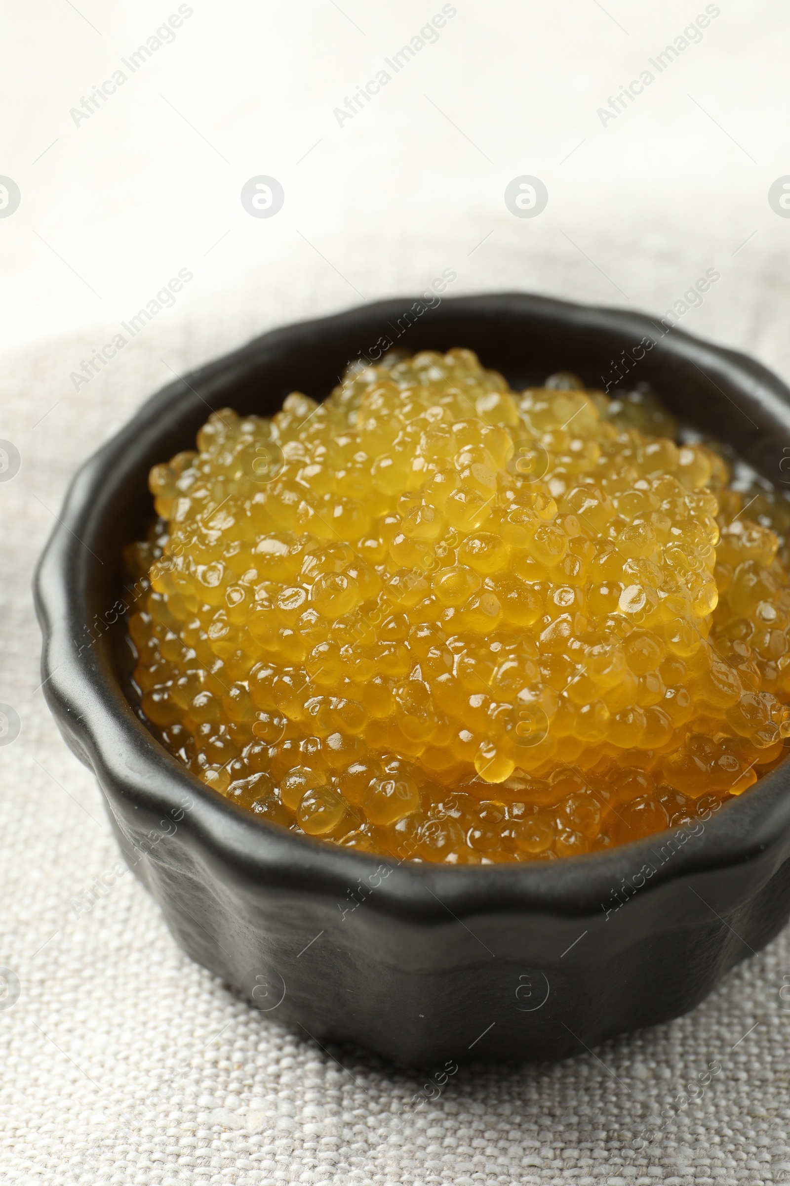 Photo of Fresh pike caviar in bowl on table, closeup