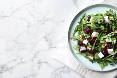 Photo of Fresh delicious beet salad on white marble table, top view. Space for text