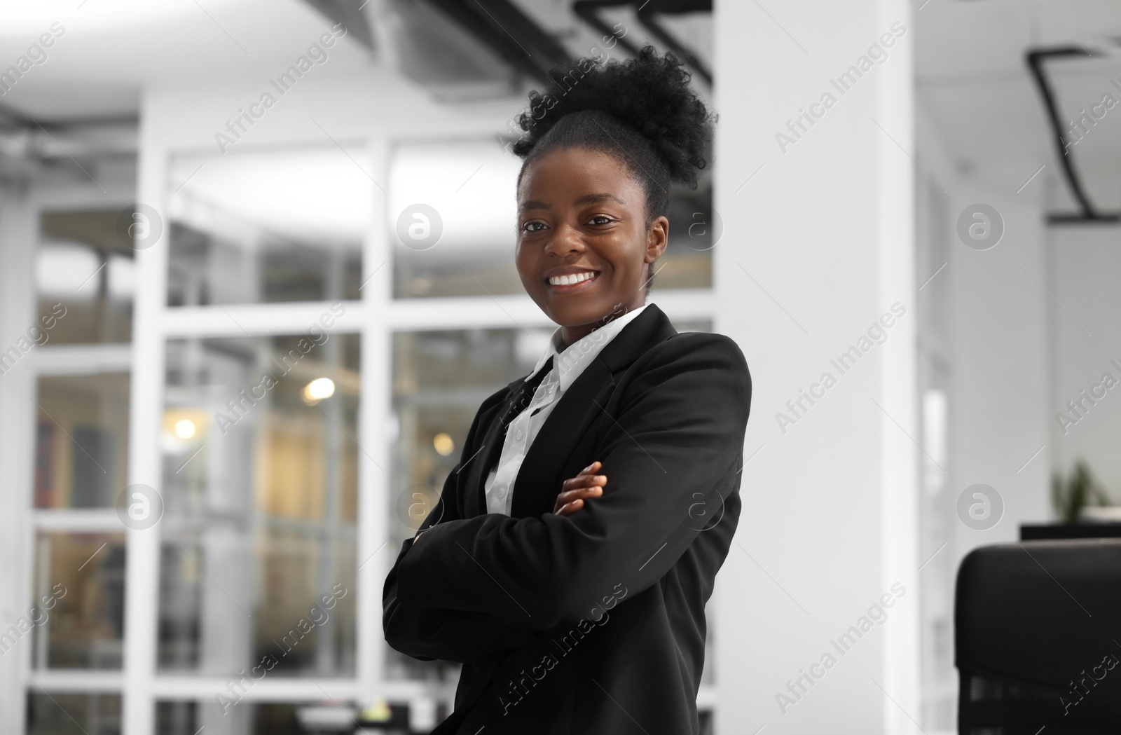 Photo of Happy woman with crossed arms in office. Lawyer, businesswoman, accountant or manager