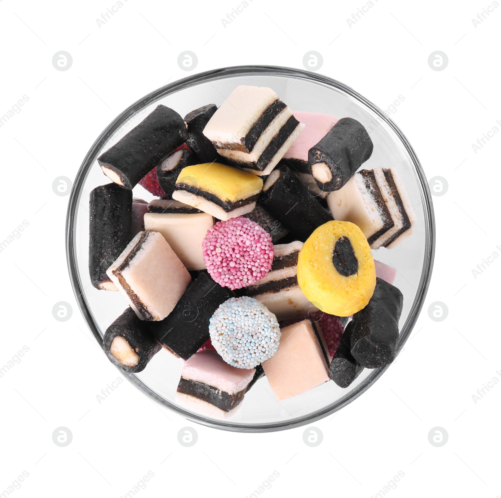 Photo of Glass bowl with many tasty liquorice candies isolated on white, top view