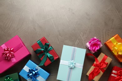 Photo of Many colorful gift boxes on grey table, flat lay. Space for text