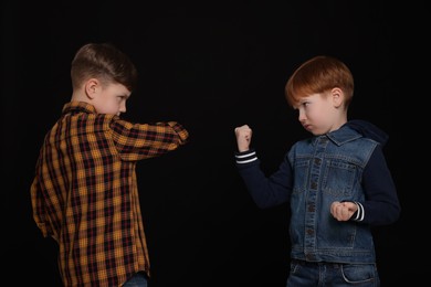 Photo of Two boys fighting on white background. Children's bullying