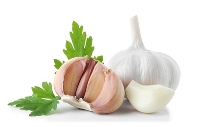 Fresh garlic and parsley on white background