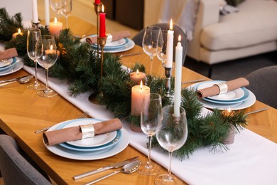 Photo of Festive table setting and beautiful Christmas decor in room. Interior design
