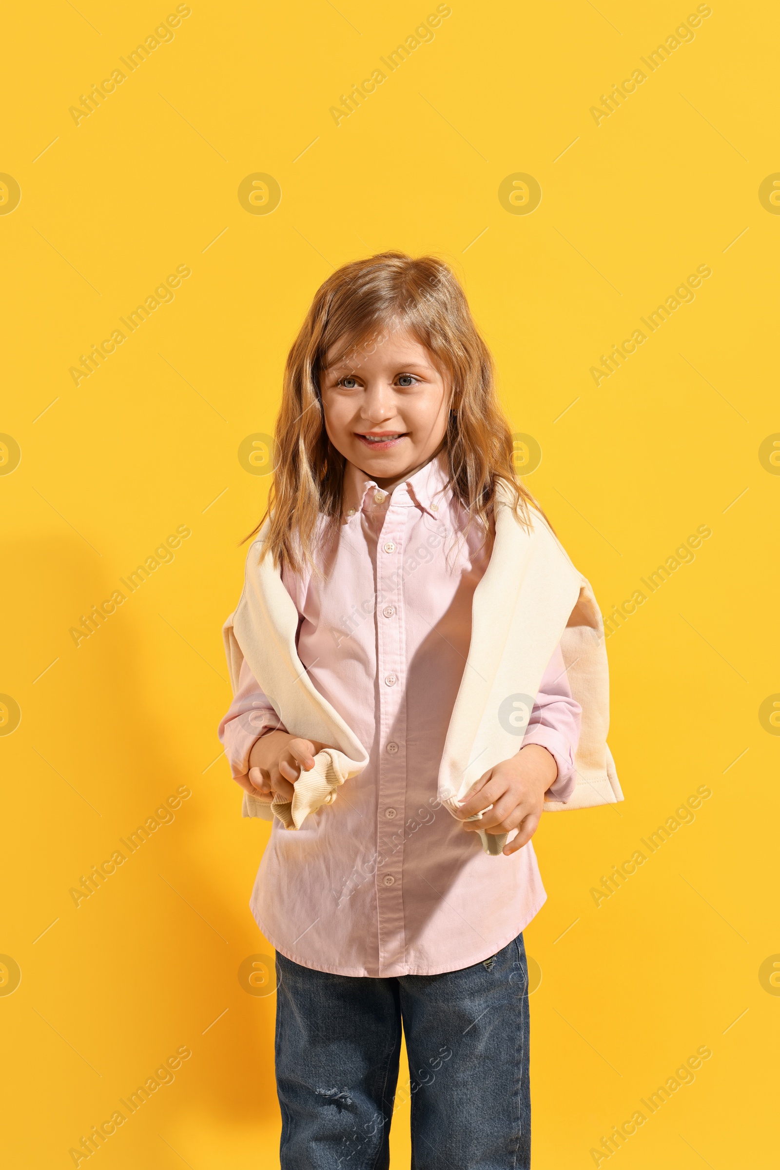 Photo of Fashion concept. Stylish girl posing on yellow background