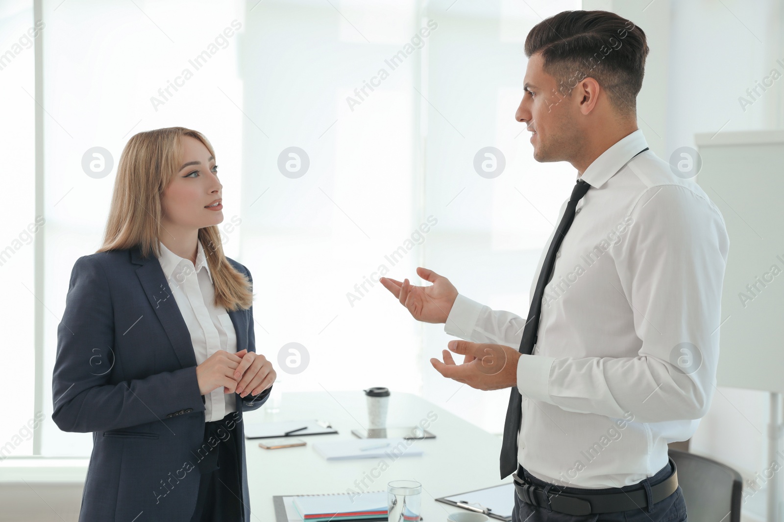 Photo of Office employees talking at workplace during break