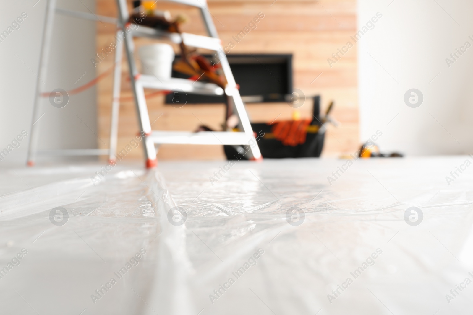 Photo of Stepladder and different tools in room. Interior renovation