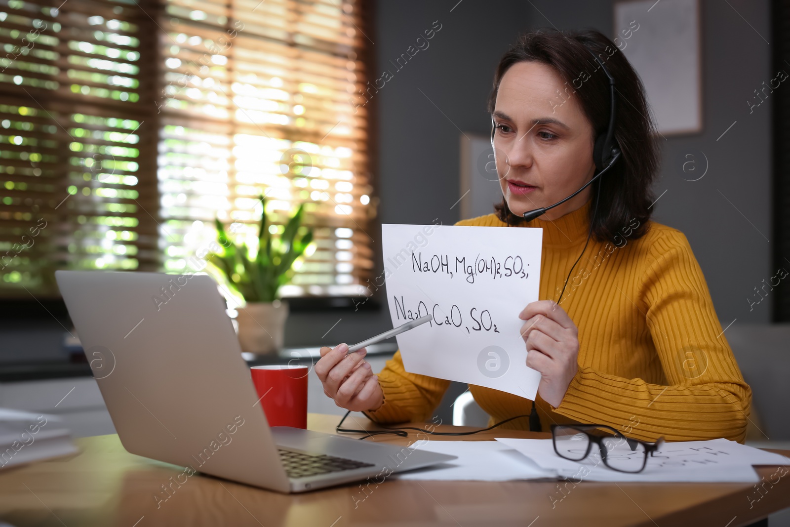 Photo of Teacher conducting online lesson at home during COVID-19 quarantine