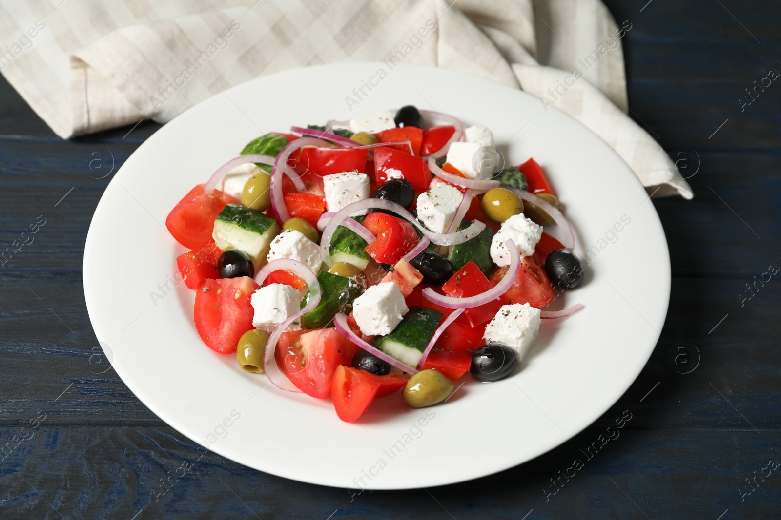 Photo of Plate with delicious fresh salad on table