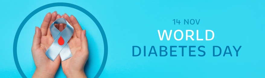 World Diabetes Day. Woman holding awareness ribbon with paper blood drop and blue circle on color background, top view. Banner design