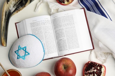 Photo of Flat lay composition with Rosh Hashanah holiday symbols on white wooden table