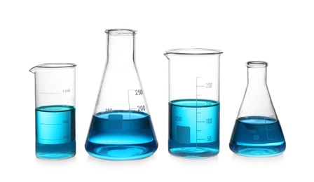 Photo of Glassware with blue liquid isolated on white. Laboratory analysis