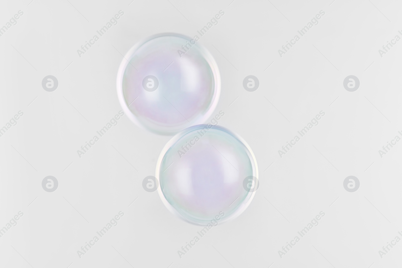 Photo of Beautiful translucent soap bubbles on grey background