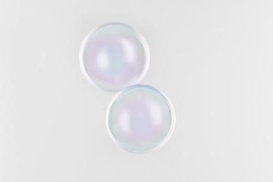 Photo of Beautiful translucent soap bubbles on grey background