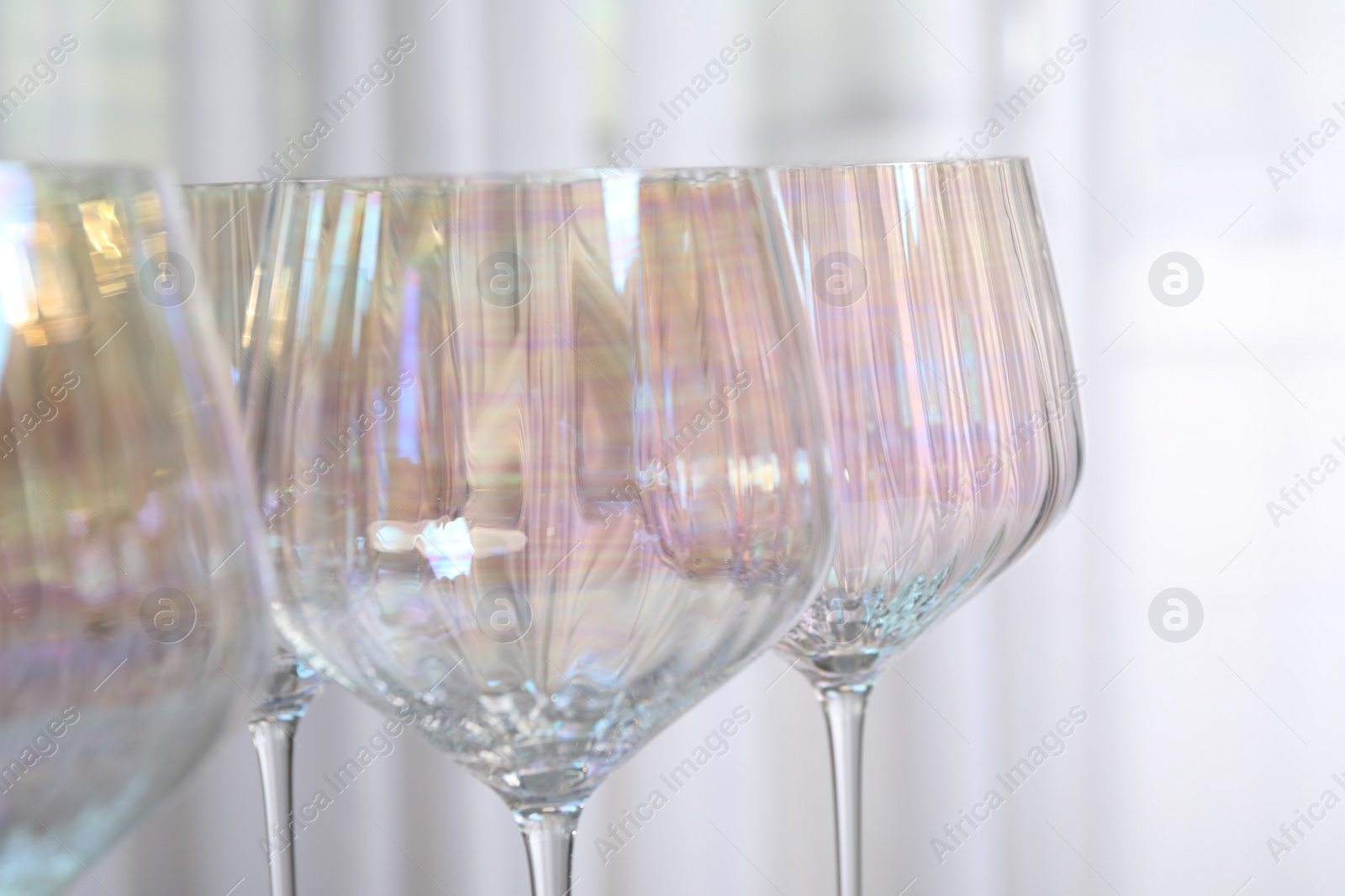 Photo of Set of glasses on light background, closeup