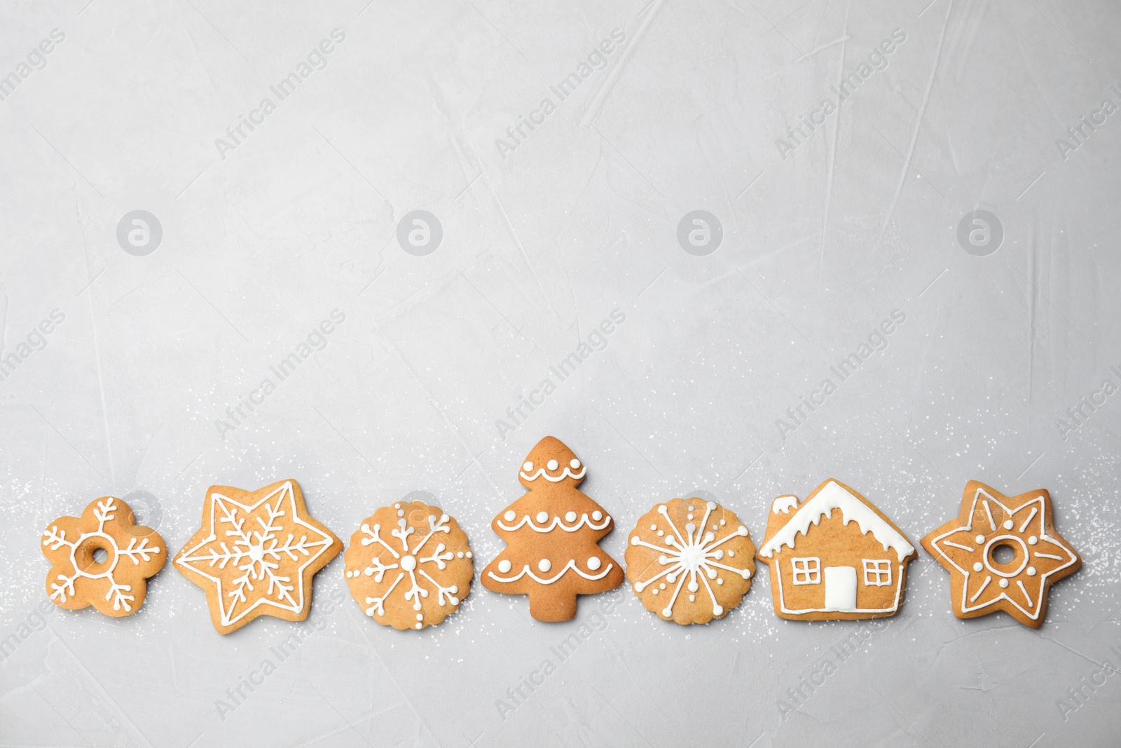 Photo of Tasty homemade Christmas cookies on gray background, top view