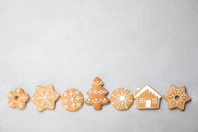 Tasty homemade Christmas cookies on gray background, top view