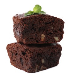 Delicious brownies with nuts and mint on white background