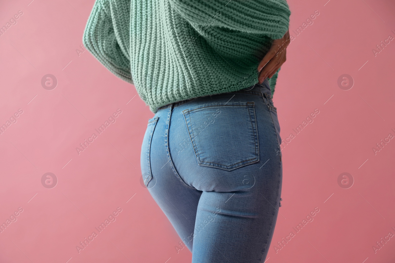 Photo of Woman wearing jeans on pink background, closeup