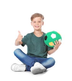 Photo of Playful little child with soccer ball on white background. Indoor entertainment