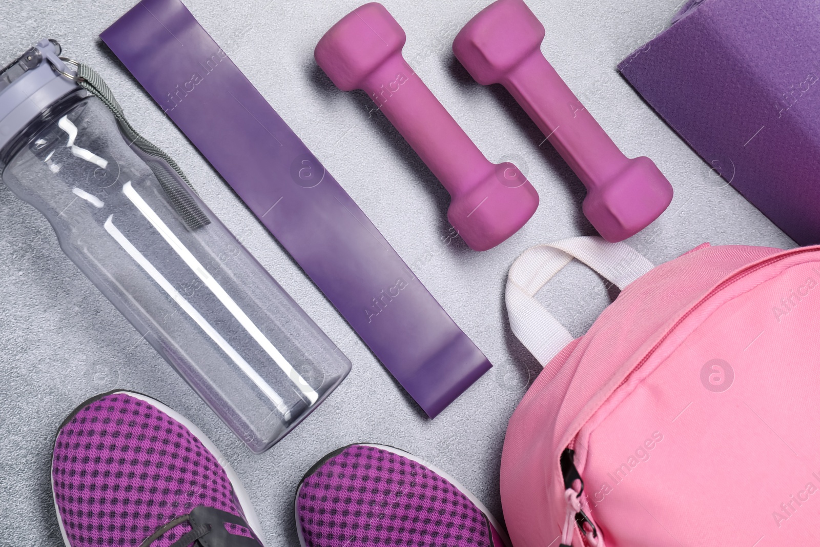 Photo of Different sports equipment on light grey table, flat lay