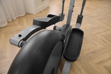 Photo of Modern elliptical machine cross trainer indoors, closeup