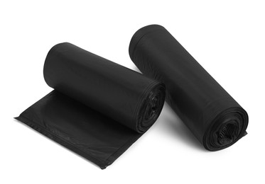 Photo of Rolls of different garbage bags on white background. Cleaning supplies