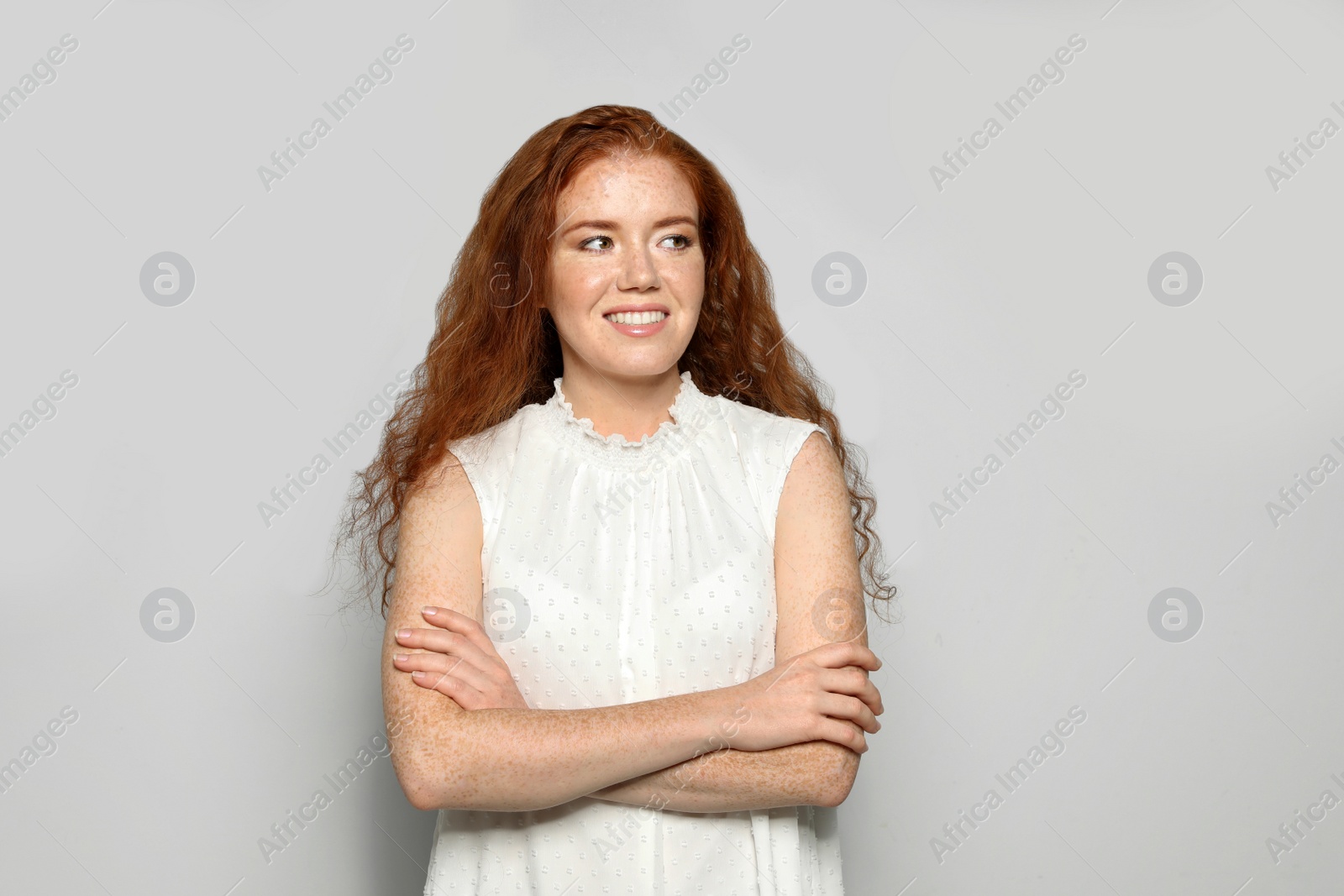 Photo of Portrait of young woman with beautiful face on grey background. Space for text