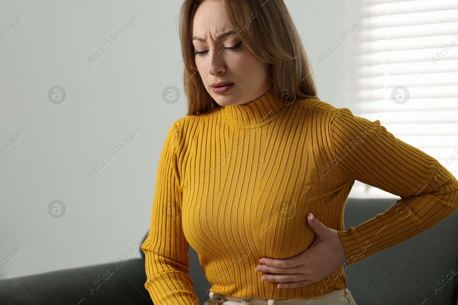 Photo of Mammology. Young woman doing breast self-examination at home