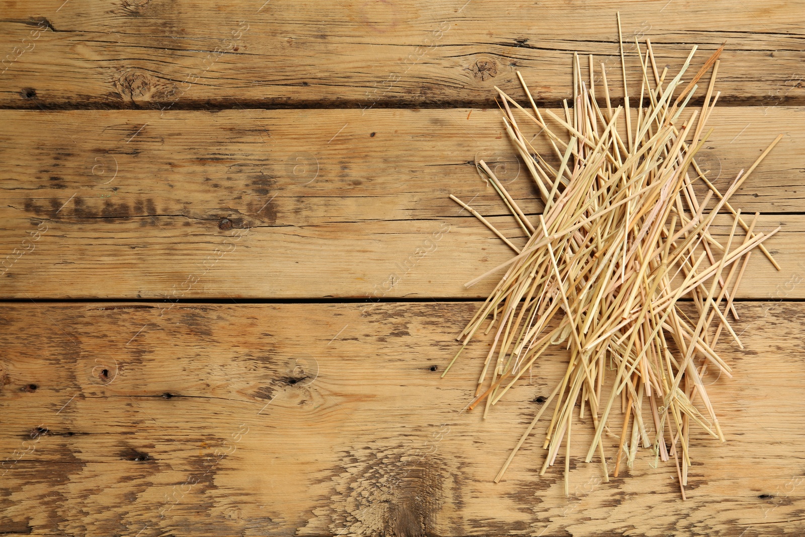 Photo of Dried hay on wooden background, top view. Space for text