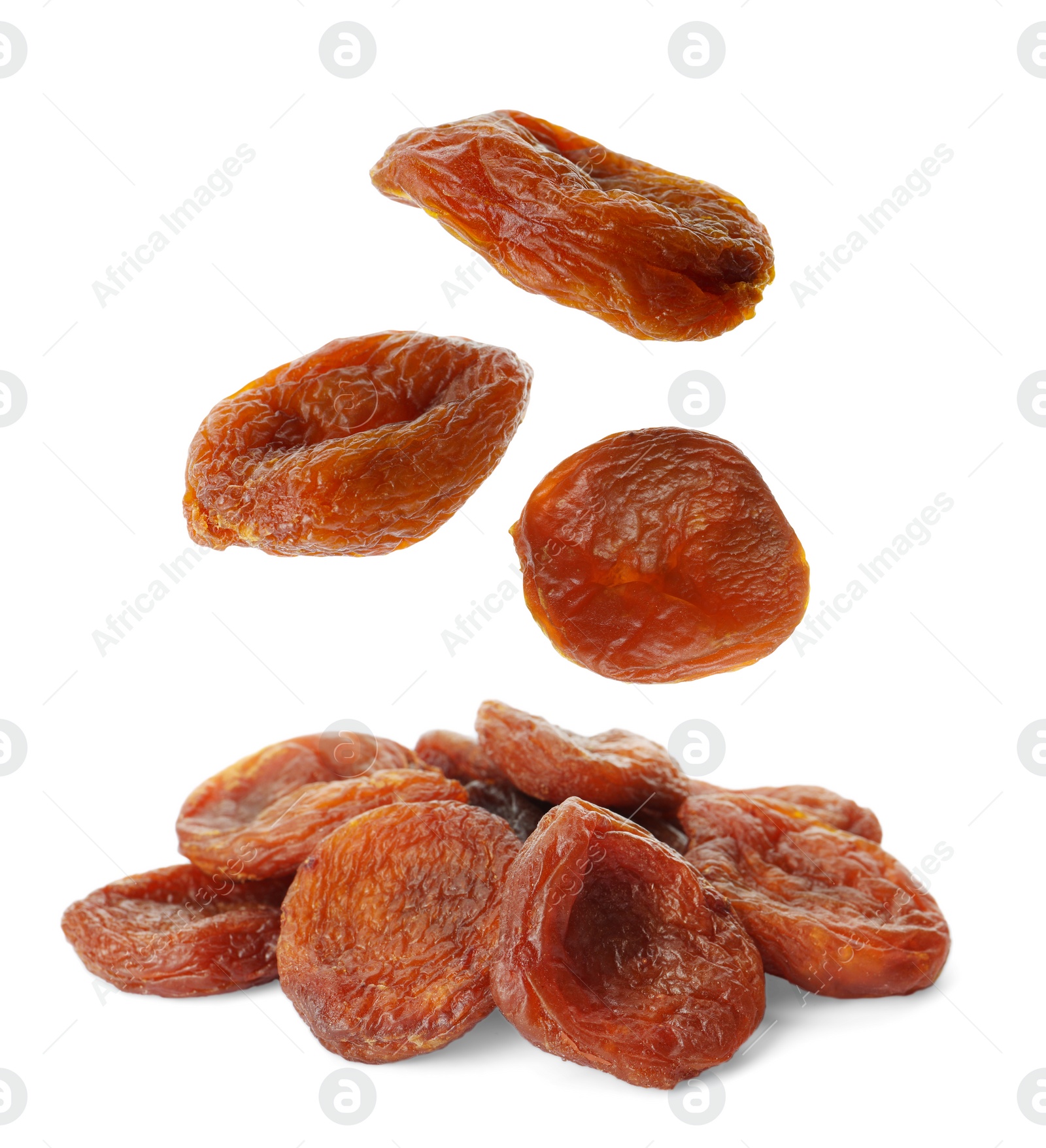 Image of Tasty dried apricots falling on white background