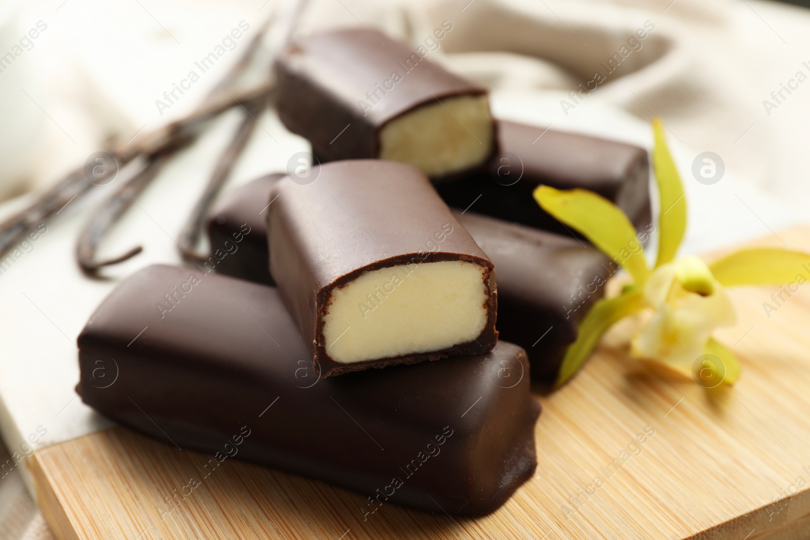 Photo of Glazed vanilla curd cheese bars on table, closeup