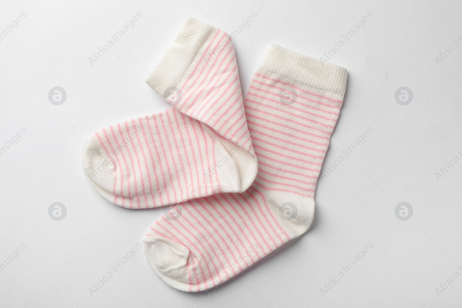 Photo of Cute child socks on white background, top view