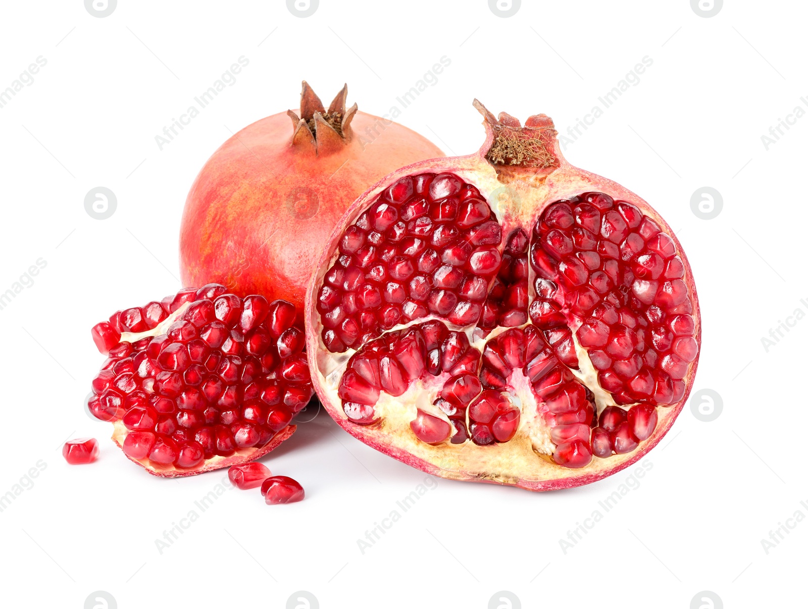 Photo of Half and whole pomegranates isolated on white