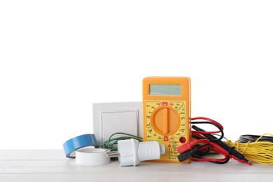 Set of electrician's accessories on wooden table against white background