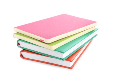 Photo of Stack of colorful notebooks isolated on white. School stationery