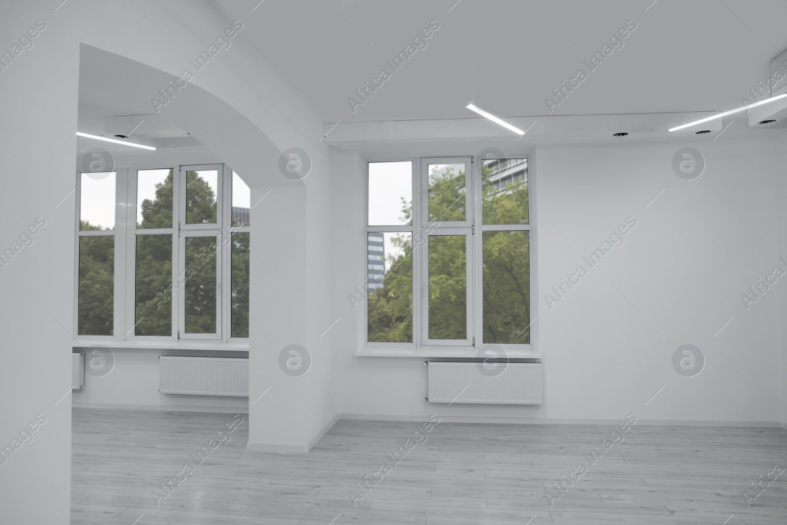 Photo of New empty room with clean windows and white walls