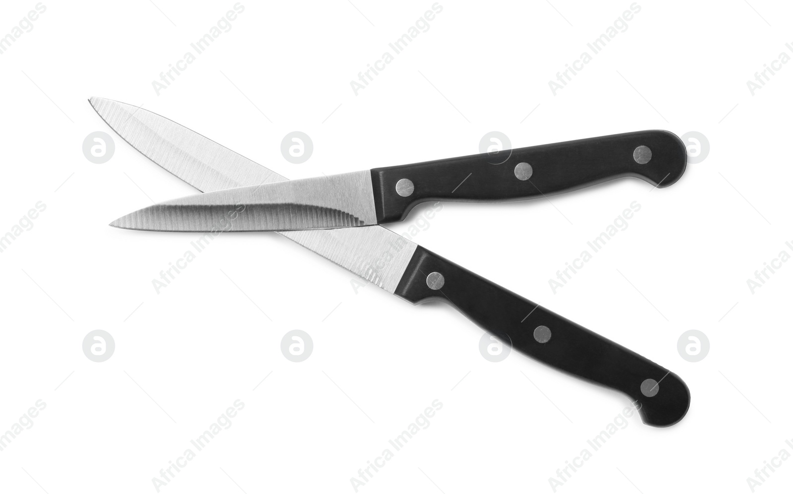 Photo of Stainless steel knives on white background, top view