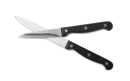 Photo of Stainless steel knives on white background, top view