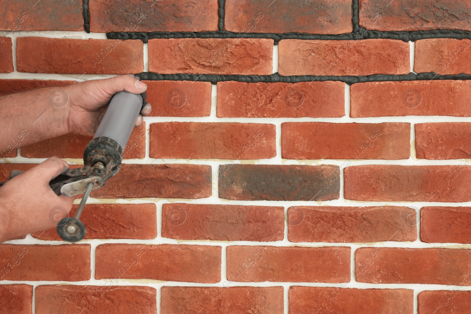 Photo of Professional builder using tiling fugue for grouting, closeup