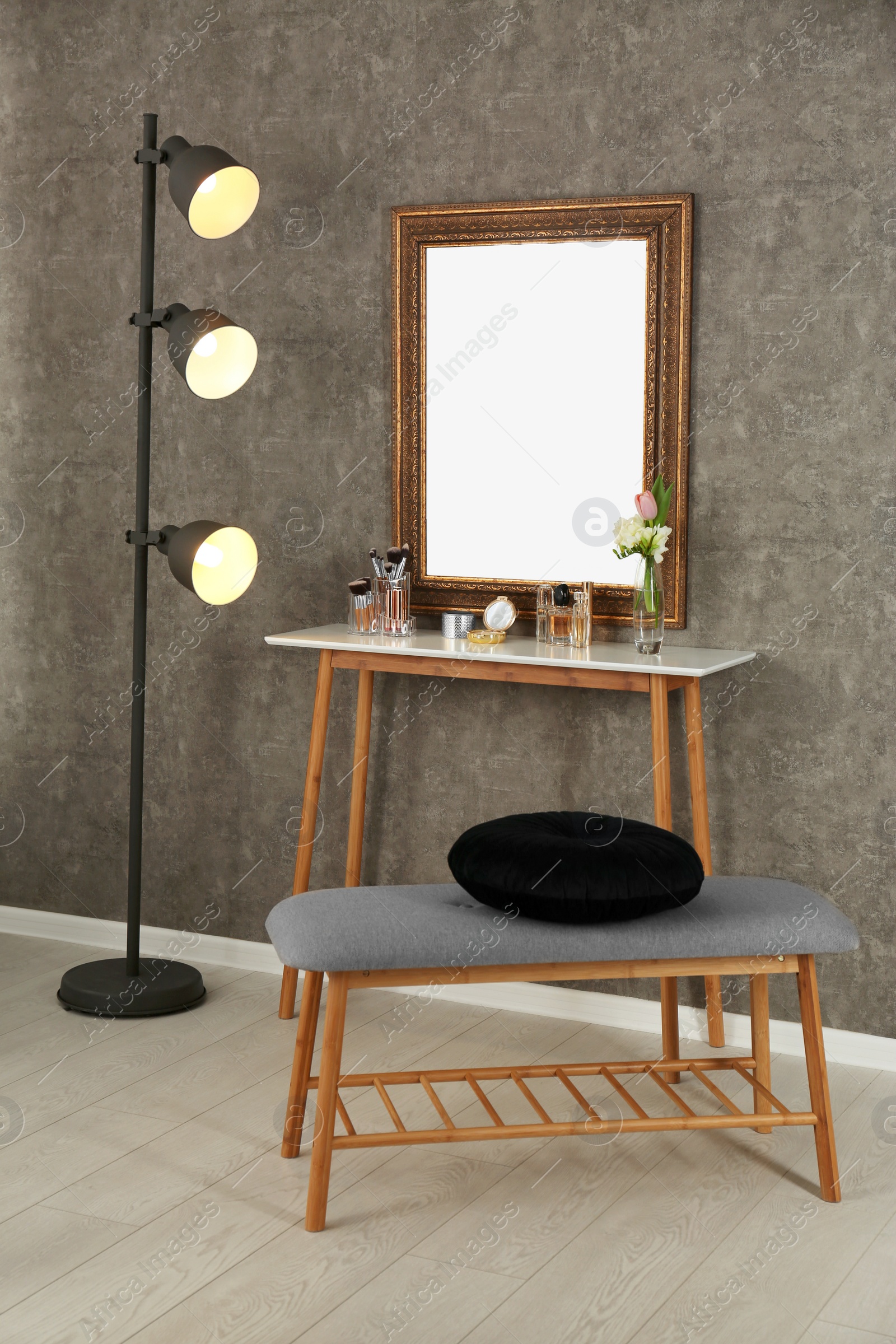 Photo of Stylish room interior with set of makeup products on dressing table