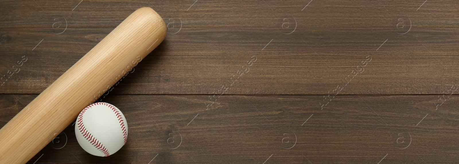 Image of Baseball bat and ball on wooden table, top view. Banner with space for text