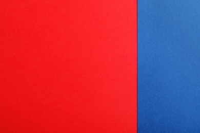 Photo of Blue and red paper sheets as colorful background, top view