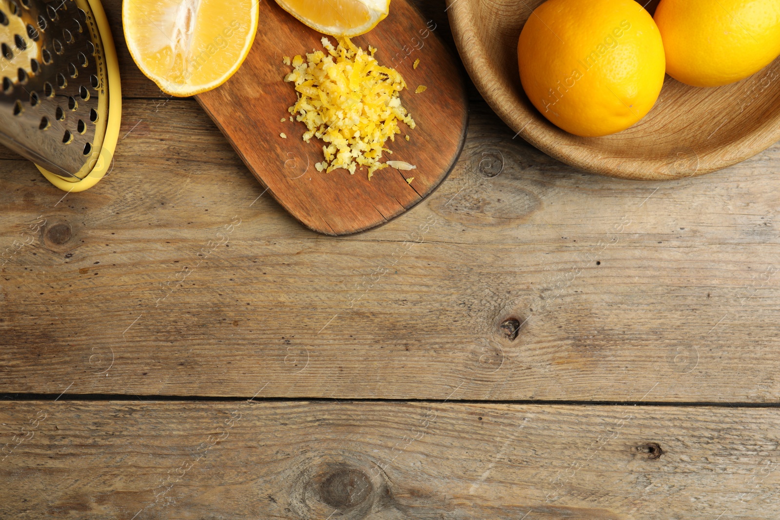 Photo of Lemon zest and fresh fruits on wooden table, flat lay. Space for text