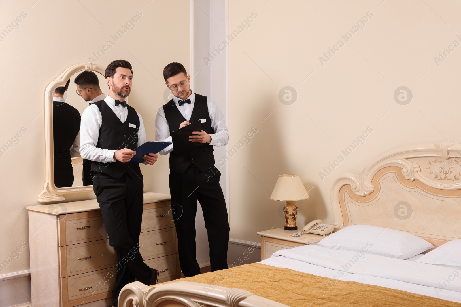 Photo of Men attending professional butler courses in hotel